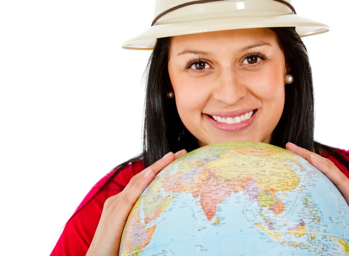 Female explorer with the globe in her hands - isolated